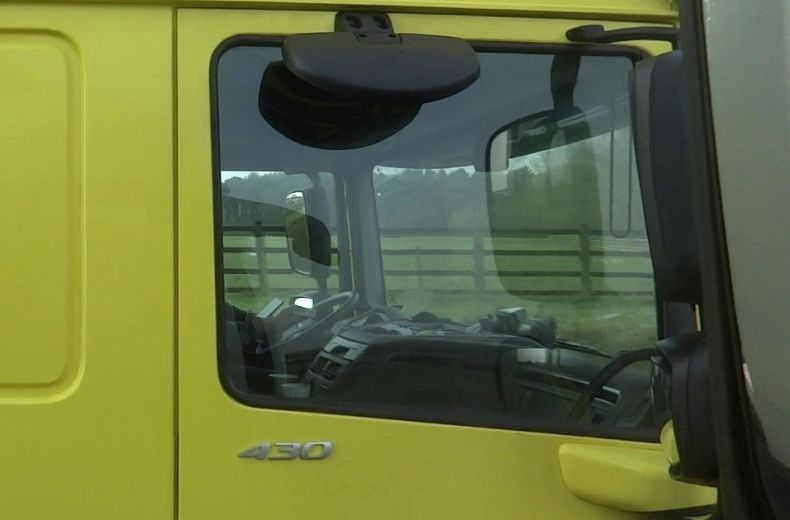 Lorry driver caught on camera holding phone and credit card