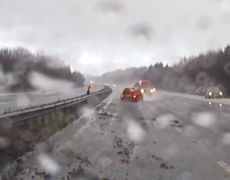 Video: Car skids backwards down motorway almost hitting traffic officer