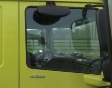 Lorry driver caught on camera holding phone and credit card